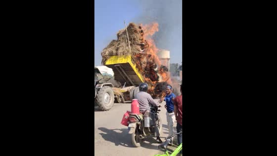 Grass truck inferno: electrical fire sparks emergency unloading in Sahson, India