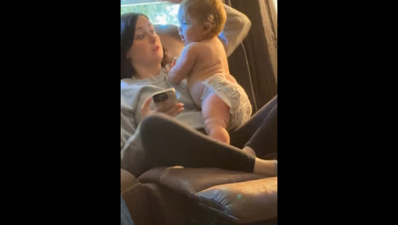 Infant says "mama" for the first time, mom reacts with humor