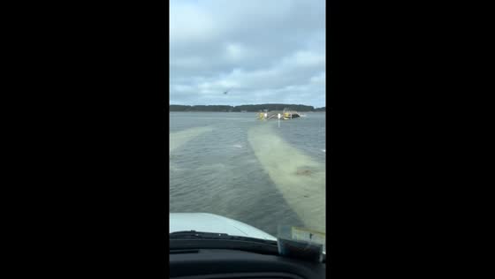 Flooding road: clear waters over Cape Cod, Massachusetts