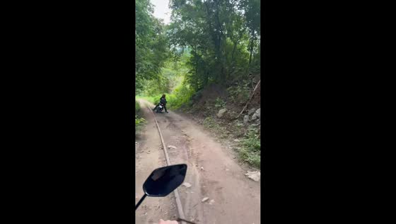 Motorcyclist loses balance on muddy road in San José, Costa Rica