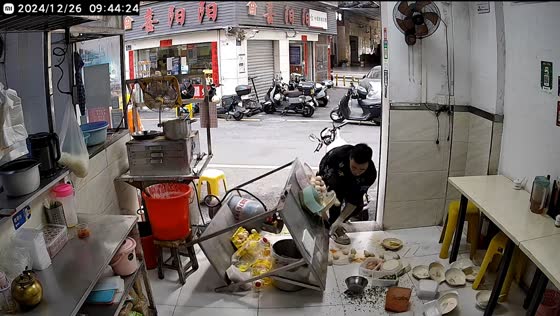 Man accidentally slips and knocks over table in Guangdong, China