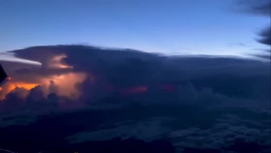 Lightning flashes behind thick clouds in USA