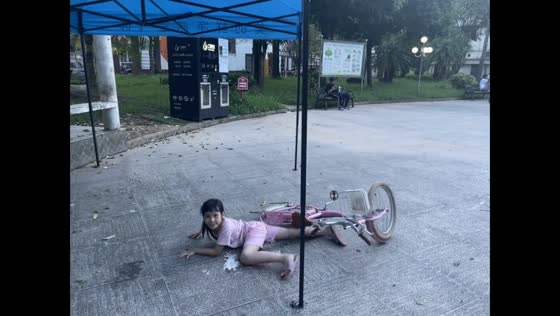 Girl’s first attempt at riding a bicycle in Guangxi, China 