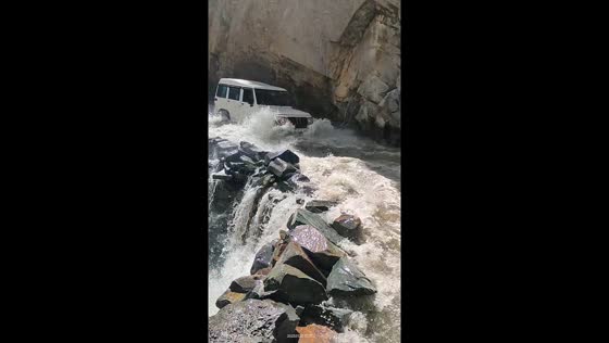 Car navigates hazardous rocky and water-filled road in Pangi, Himachal Pradesh, India