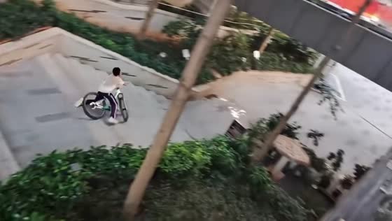 Teen falls during bicycle trick attempt on stairs in Guangdong, China