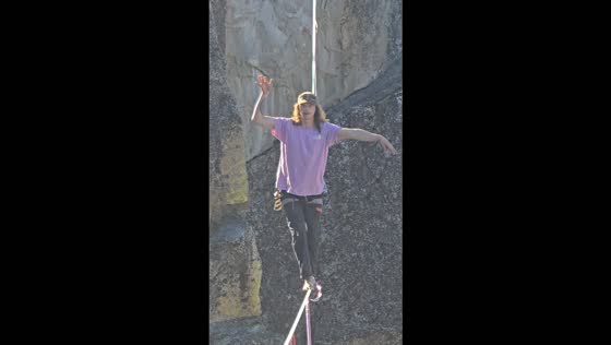 Highliner makes daring crossing on a slackline above Yosemite Valley, California, USA