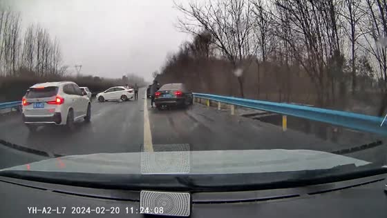 Driver navigates through still cars after possible accident in China
