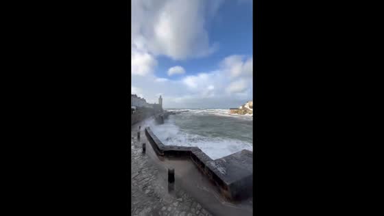 Massive waves hit Porthleven harbor during Storm Chandra in Cornwall, UK