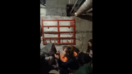 Students in the basement of the hostel sing songs during shelling in Kyiv