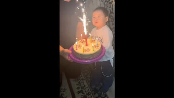 Little boy blows birthday candle in Almaty, Kazakhstan