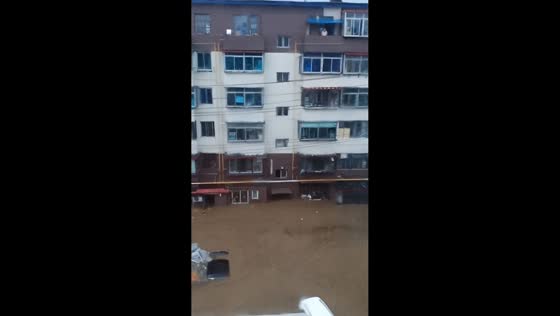 High-angle view shows flooded road near residential buildings in Liaoning, China