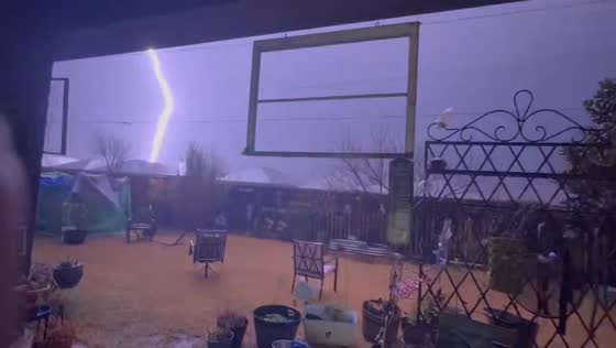 Hailstorm and lightning strike captured during a storm in Crowley, Texas, USA