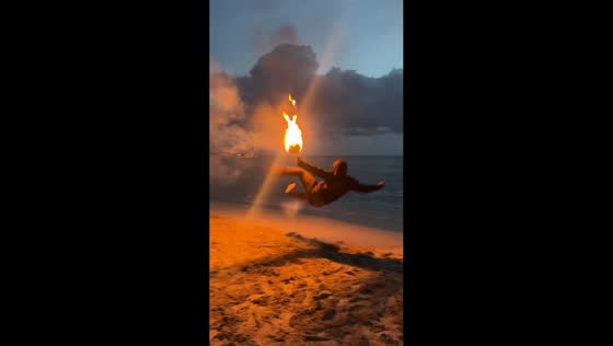 Man plays with flaming football on beach in Puerto Viejo, Costa Rica