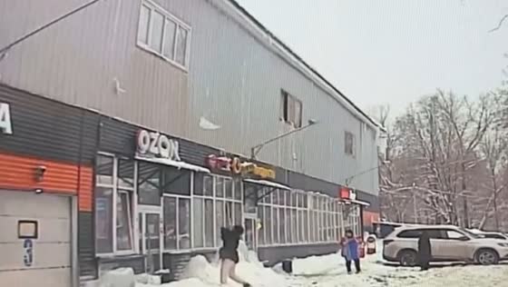 Snow and ice block strikes woman outside store in Ivanteyevka, Russia