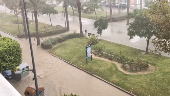 Heavy rainfall floods streets and park pathways as muddy water rushes through El Ejido, Spain