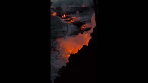 Lava flow meets ocean during eruption near Sainte‑Rose, Réunion, France