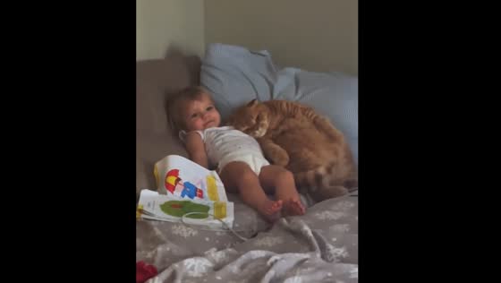 Daughter and cat share a sweet moment on the couch