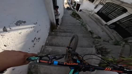 Cyclist falls after fast descent down stair path in Taxco, Mexico