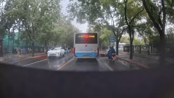 Motorcycle riders fall after bike slides on slick road in Beijing, China
