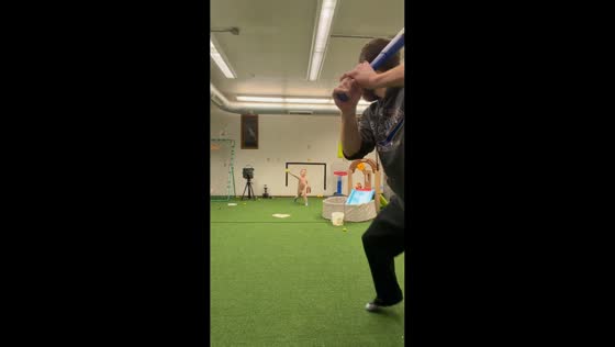 Father and son playing indoor baseball in Illinois, USA