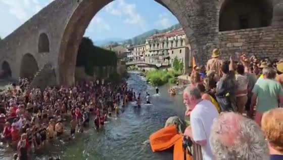 Crowds cool off in Ter River during Sant Patllari Festival in Catalonia, Spain