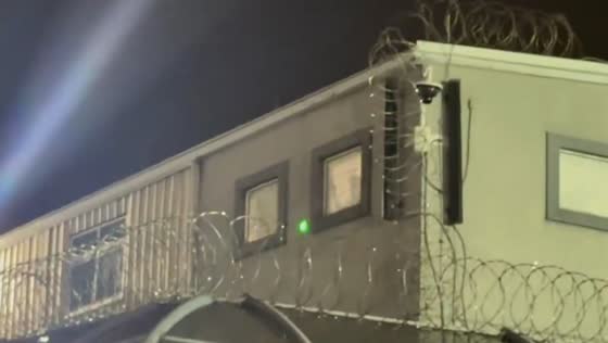 Protesters outside Delaney Hall receive light signals from detainees in Newark, New Jersey, USA