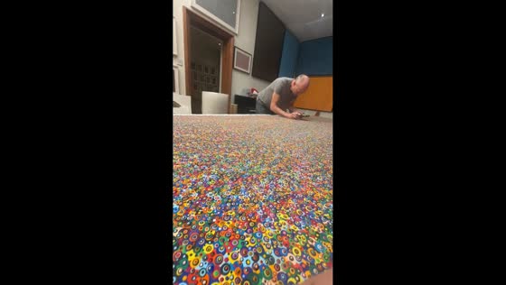 Man creates artwork while child plays piano in UK room