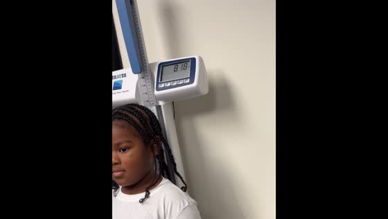 Children step on clinic scale in Dallas, Texas, USA