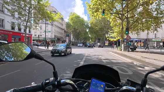 Motorcycle rider crashes into a Porsche Cayenne at an intersection in Paris, France