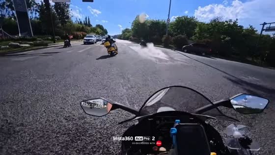 Motorcyclist slips after hitting water patch at intersection in Shandong, China