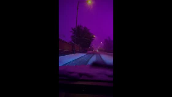 Snow blankets Birmingham under a pink sky in West Midlands, UK