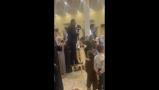 Cameraman skillfully maneuvers on a chair during a wedding in Khasavyurt, Russia