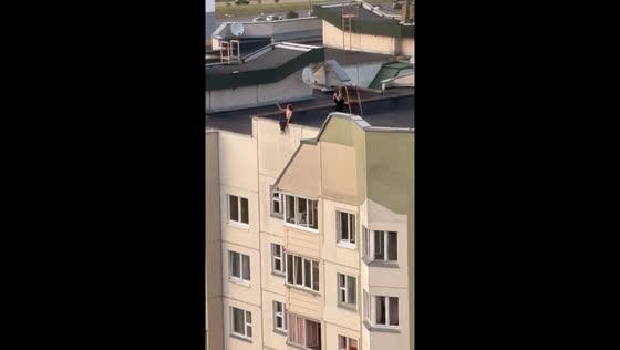 Girl sits on roof edge in Dambroka, Belarus