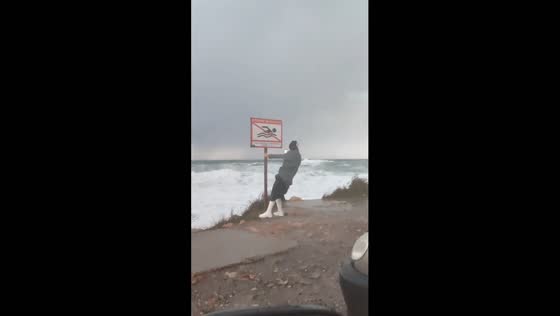 Risky storm video: woman braves winds for footage