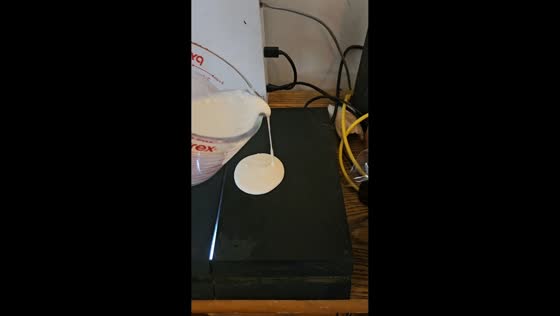 Man humorously cooks pancakes on a PlayStation 4 in Newnan, Georgia, USA