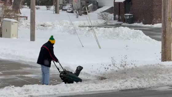 Clearing heavy snow from the roadway in Highland, Indiana, USA