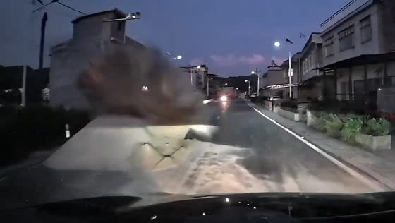 Car crashes into sand pile on road in China