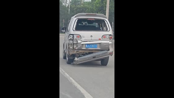 Heavily damaged minivan wobbles down the road in Tianjin, China