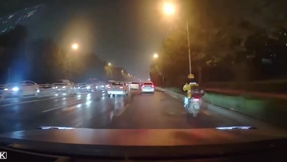 Motorcycle trips over uneven manhole covers in Liaoning, China