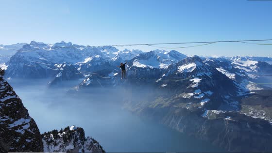 Mountain aerial slacklining: suspended lady's stunning maneuvers