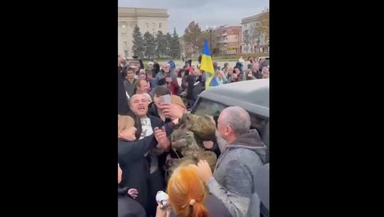 People together with Ukrainian soldiers celebrate the liberation of the city of Kherson