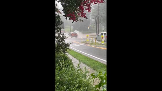 Continuous rainfall causes road flooding in Silver Spring, Maryland, USA