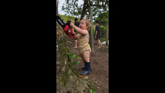 Toddler imitates a chainsaw while playing in Armazém, Santa Catarina, Brazil