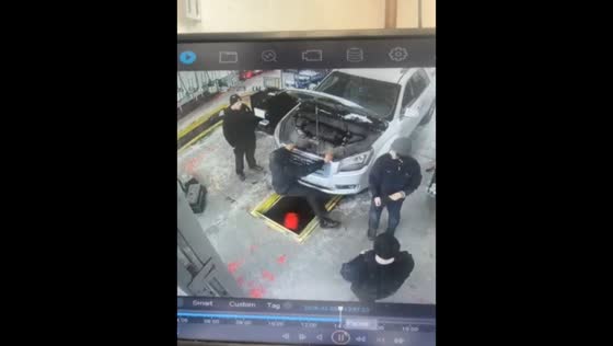 Car mechanic slips into service pit in Indianapolis, Indiana, USA