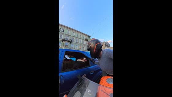 Woman on big bike interacts with dog in Saint Petersburg, Russia