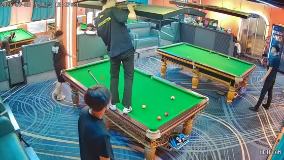 Cue ball gets stuck in overhead light during billiards game in Liaoning, China