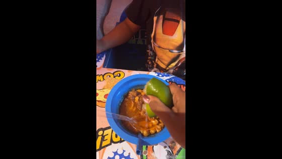 Boy makes sour face after tasting food with lime juice in Chicago, USA