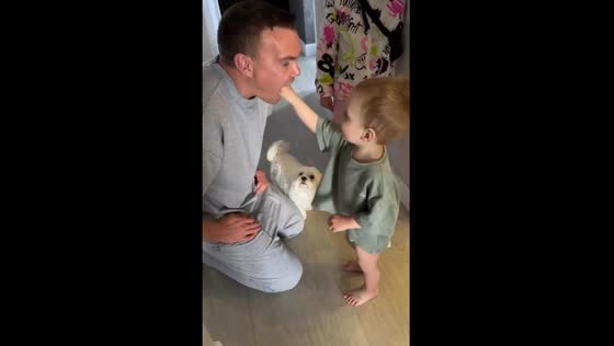 Playful parenting moment: child hilariously 'chokes' parent during play