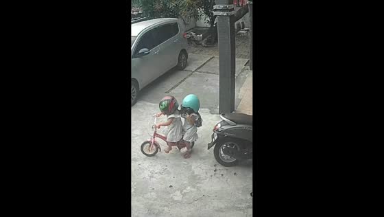 Twin toddlers roleplay motorcycle taxi ride in Indonesia