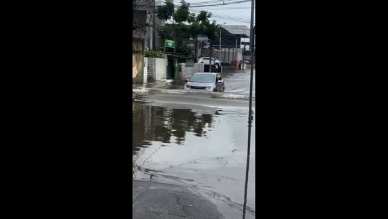 Flooded streets as car drives through deep water in Recife, Brazil 